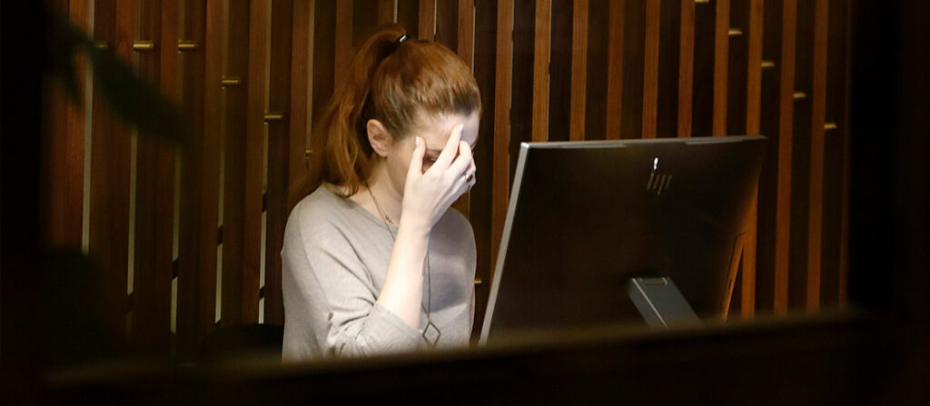 Žena sediaca pred monitorom.